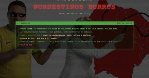 Tela de acesso do Sistema Ancine Digital alterada por invasores, com a frase 'Nordestinos burros' e mensagens políticas
